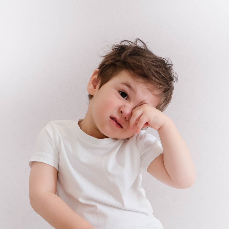Little boy itchy his eyes with tear