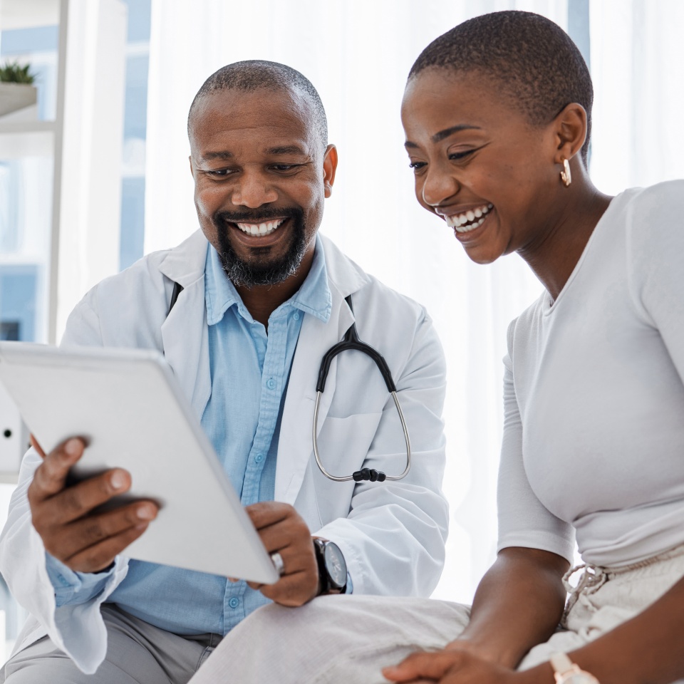 Doctor, healthcare and medicine with a patient talking test results and progress on a tablet in a hospital clinic. Trust, help and medical consulting with a professional medicare worker in his
