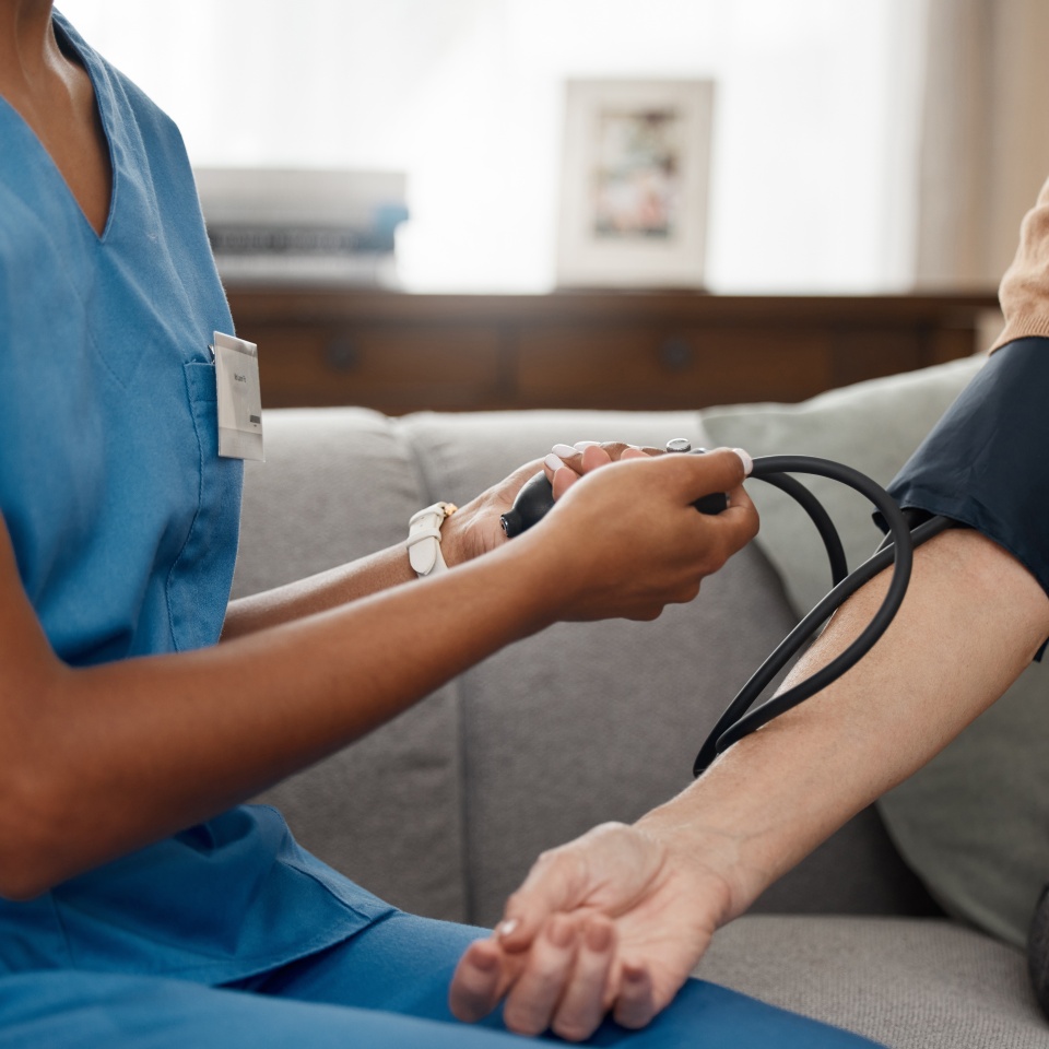 Take the test, live your best. Shot of a doctor examining a senior woman with a blood pressure gauge at home.
