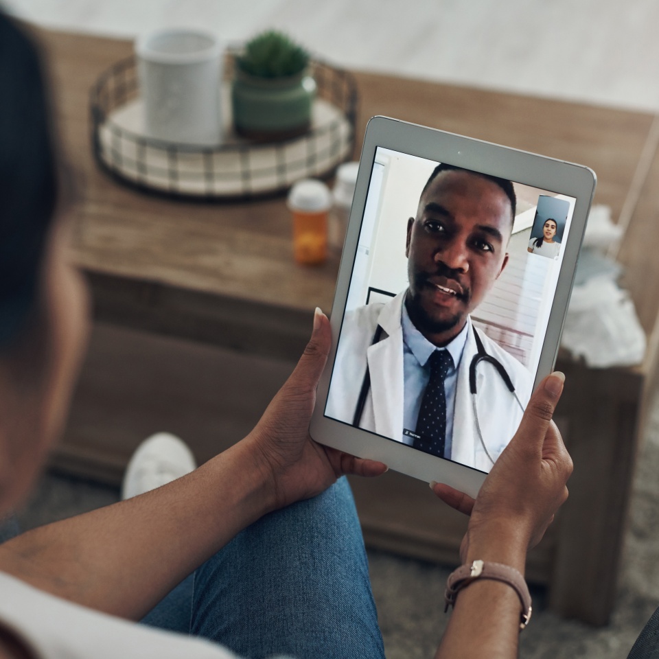 Tablet, remote consulting with a doctor and a patient in the home for healthcare, medical or insurance. Video call, telehealth and contact with a person talking to a medicine professional online