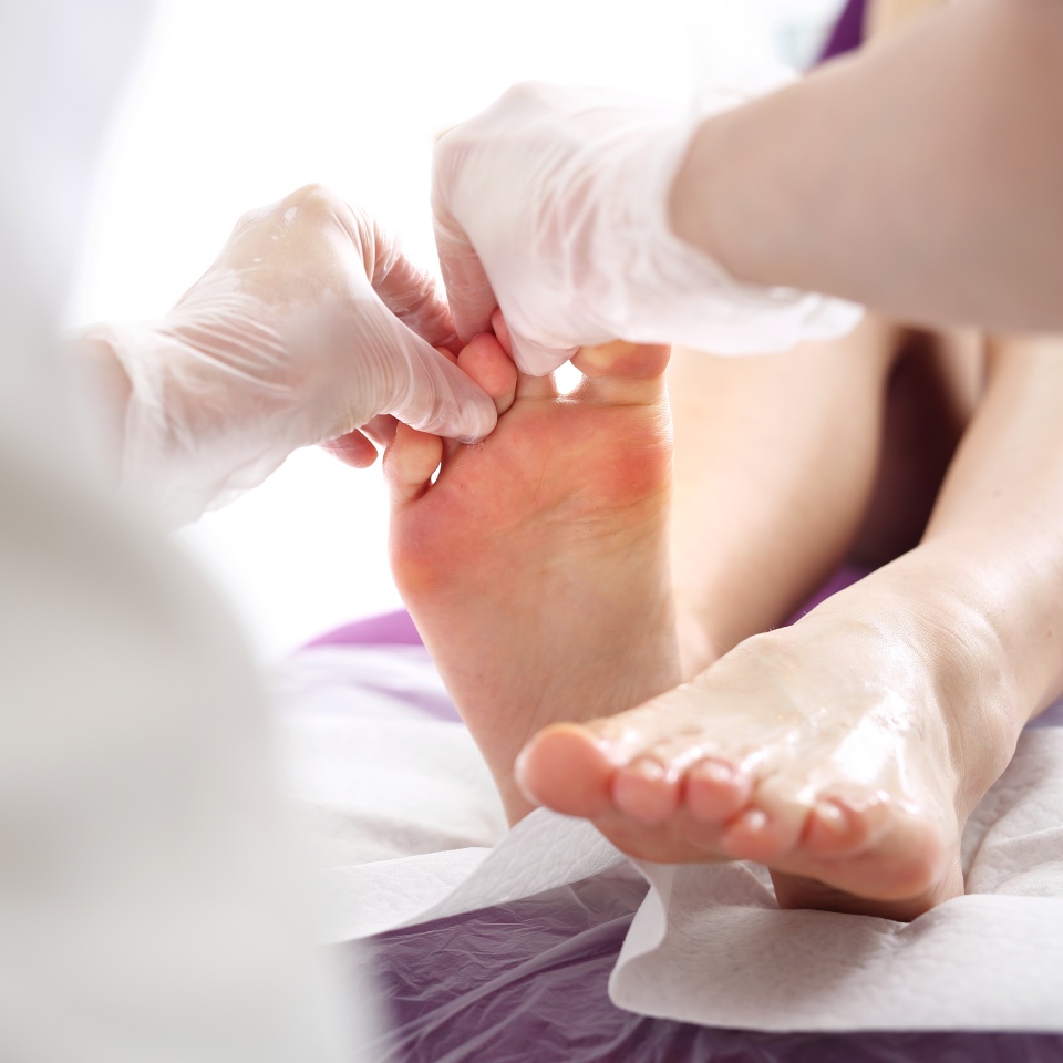 Toe and nail fungus. Woman at a dermatologist.