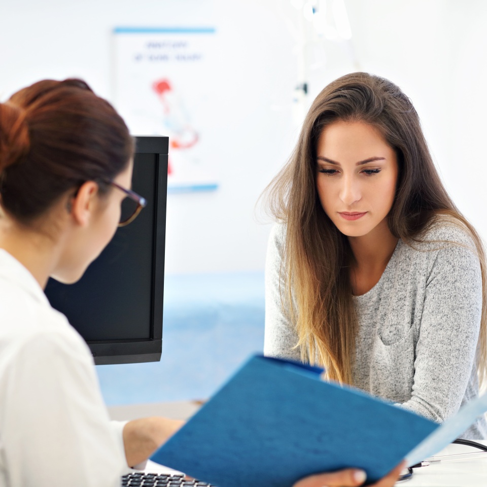 Picture of adult woman having a visit at female doctor's office