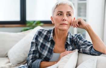 Depression and sadness concept. Caucasian middle-aged woman suffering from health issues at home. Mature housewife thinking having negative feelings, nostalgy