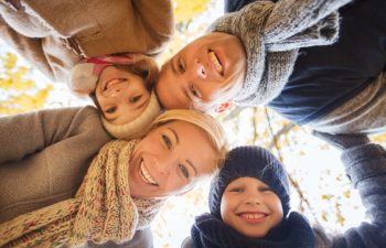 family, childhood, season and people concept - happy family in autumn park